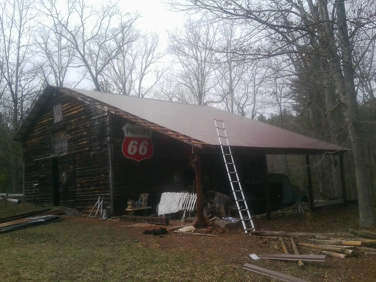 New metal roof on an open sided timber barn with a vintage sign in Jasper
